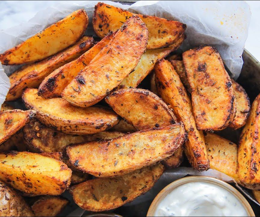 Perfectly roasted potato wedges with a deeply golden crust, tossed in a fiery spicy paprika mix, served with sour-cream dipping sauce.