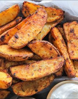 Perfectly roasted potato wedges with a deeply golden crust, tossed in a fiery spicy paprika mix, served with sour-cream dipping sauce.