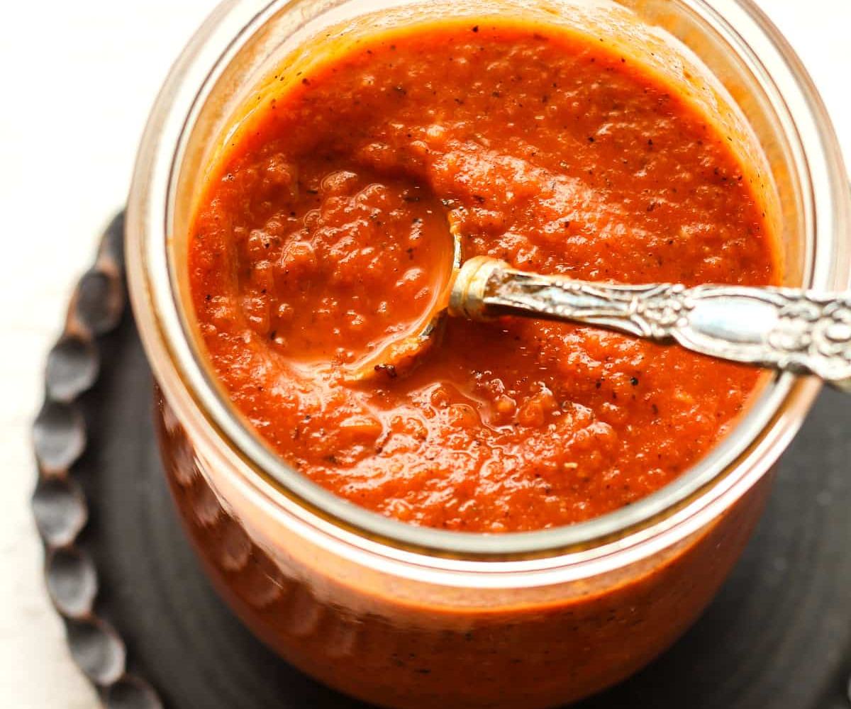 A jar of thick, vibrant tomato marinara sauce made from tomato puree, herbs, and olive oil. Perfect for pasta, pizza, or dipping — rich, smooth, and full of flavor.