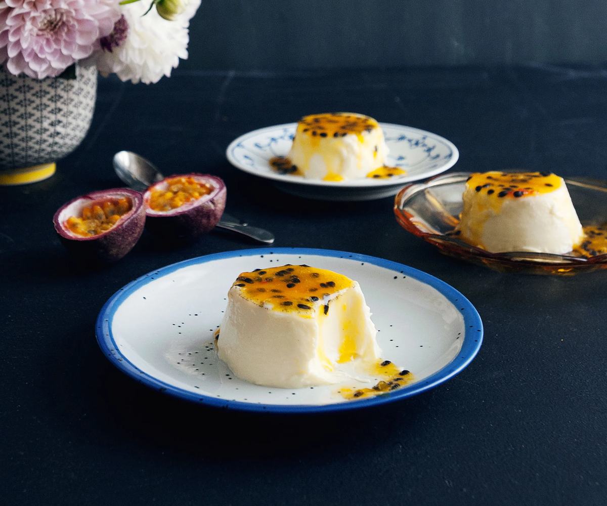 Three servings of silky, creamy vanilla panna cotta topped with bright passion fruit sauce.